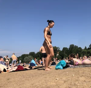 Gorgeous milf rubbing sun lotion in her skin at the beach, with a couple of her milf friends