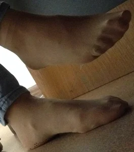Young Girl’s Feet in Pantyhose Under Desk Closeup
