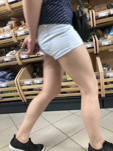 Girl with Muscular Legs in Mini Shorts Store Candid Closeup