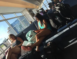 Asian Girl in Mini Shorts With Hot Crossed Legs Sitting at the Airport Creepshot