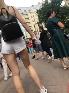 Hot Candid Girl in a Top, Shorts and Sneakers Skinny Legs Closeup Creepshots Gallery on the City Street
