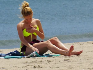 Sexy ass blonde milf on the beach in a thong with cameltoe and bending over