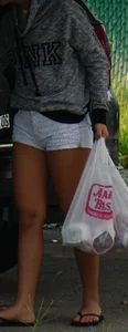 Girl next door teen neighbor bringing in groceries in short jean shorts