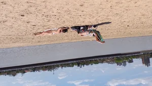 Girl laying out getting sun in a white thong bikini
