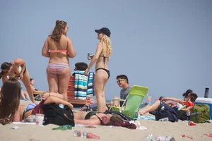 Two thick white girls in bikinis on the beach with big asses