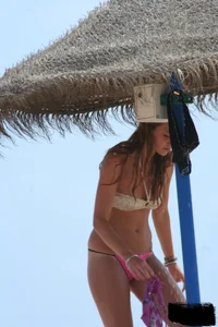 Hot beach girl undressing and going topless