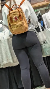 Beautiful shape booty brunette hair Girl in black legging at clothing shop