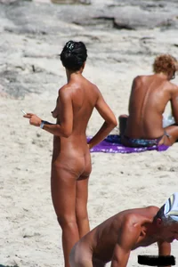 Smoking milf at a nude beach with a hairy pussy