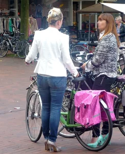 Candid milf in tight jeans with a bike