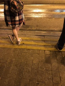 Cute Teen in Shorts on the Tram Stop