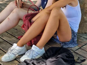 Cutie sitting on the ground wearing a skirt, white panties flash