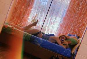 Barefoot Girl Lying in Bed in Panties and a Top Mirror Selfie