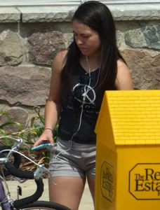Thick brunette listening to music in shorts