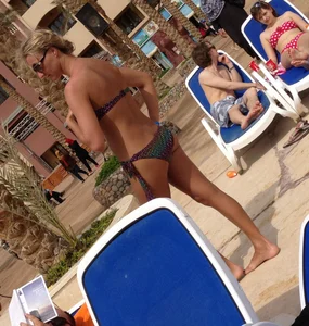 Sexy blonde babe in a bikini at the pool
