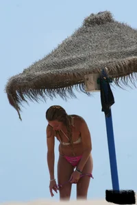Hot beach girl undressing and going topless