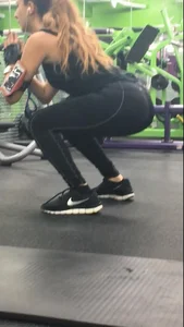 Sexy gym girl with a nice body in leggings as she works out