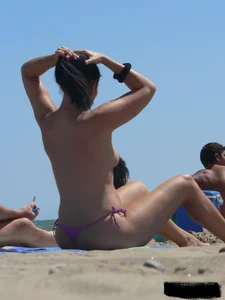 Purple thong topless lady on the beach gets oiled up by her husband
