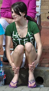 Cute brunette sitting in white shorts and showing a little cleavage