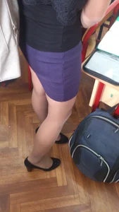 College Student Girl in a Skirt, Pantyhose And High-Heeled Shoes Standing in Class