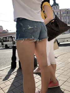 Awesome ass in fringed denim shorts and perfect legs, candid girl's street photos