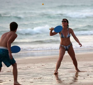 Older lady playing on the beach in her bikini