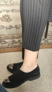 Teen college girl's ankles and feet in shoes closeups (sitting with her legs crossed)