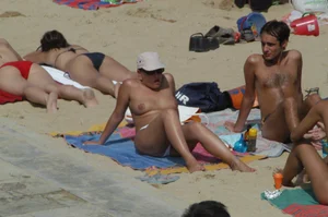 Topless girls on a beach in Barcelona