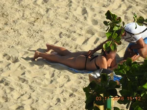 Big booty beach babe laying out in thong