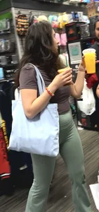 Hot brunette milf in green yoga flare at GameStop
