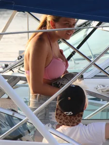 Skinny blonde girl on the beach in her pink and white bikini