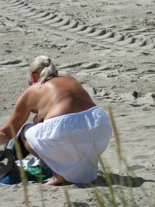 Mature blonde lady on a nude beach with big boobs