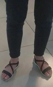 Feet in sandals closeup sneaky photo