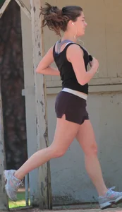 Cute girl running in short shorts