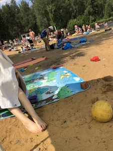 Skinny Girl Sitting Under a Towel at a Beach Photos
