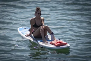 Brunette in thong bikini shows ass, crotch, boobs, and feet