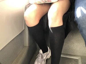 A Very Cute And Skinny Candid Teen Girl Wearing Glasses, A Skirt And Knee Socks Sitting in a Public Bus, Closeups of Her Legs