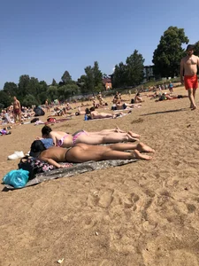 Gorgeous milf rubbing sun lotion in her skin at the beach, with a couple of her milf friends