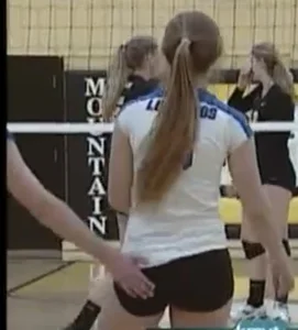 Teen volleyball girls touching each other’s booties