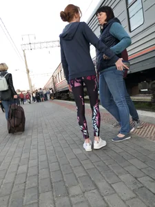 Skinny Teen With Nice Thin Legs in Spandex Tights Hugging Her Friends at a Railway Station Photos