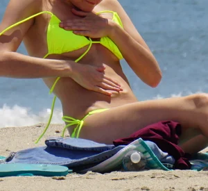 Sexy ass blonde milf on the beach in a thong with cameltoe and bending over