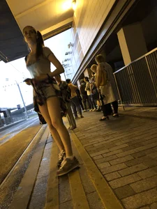 Cute Teen in Shorts on the Tram Stop