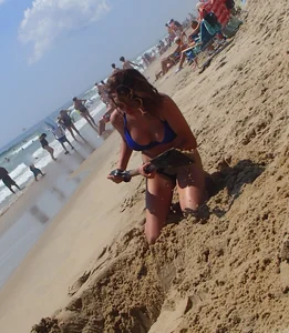 Girl with great tits playing in the sand at the beach