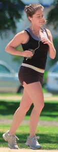 Cute girl running in short shorts