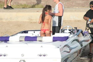 Brunette on a boat in red thong bikini with a tight little ass