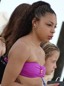 Sexy light skinned black girl in a purple bikini busted