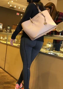 Brunette jewelry shopping in leggings with a nice ass