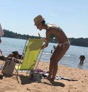 Swedish beach blonde girl in white and green bikini