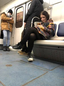 Cute Teen in Black Pantyhose And Sneakers Tying Her Shoelaces in a Subway Train