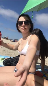 Friends on the beach in bikinis and flashing
