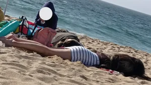 Beautiful Teen with Miniskirt resting on the beach